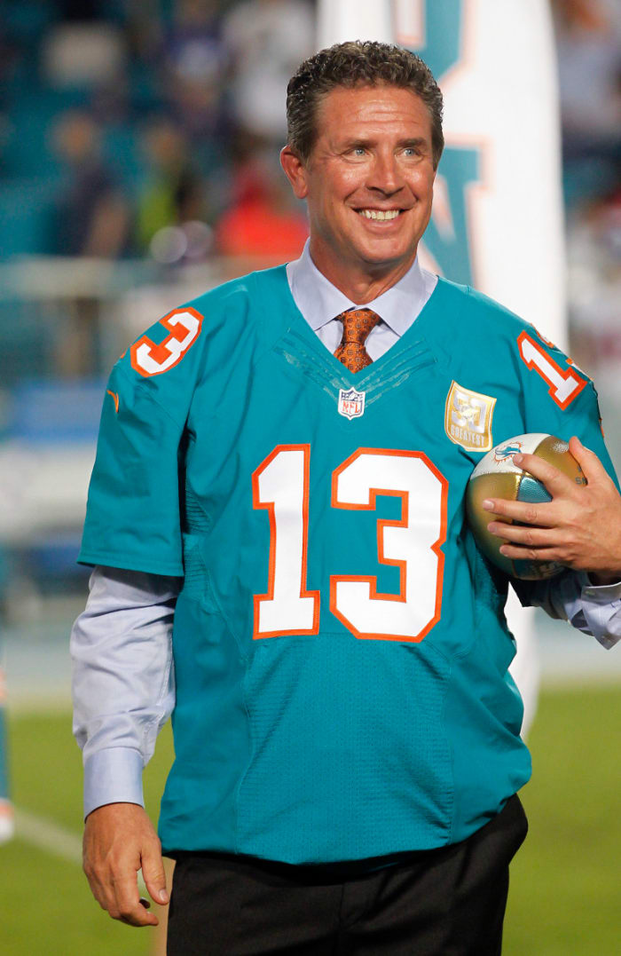 Former Dolphins quarterback Dan Marino holds his commemorative ball during a halftime ceremony at Sun Life Stadium in 2015 after being named a member of the franchise's all-time team.